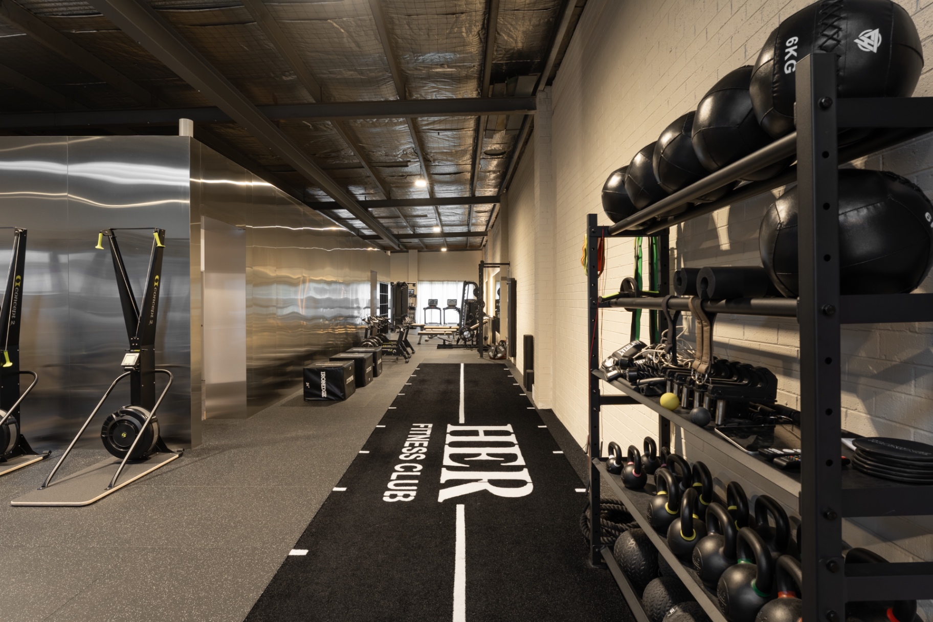 The HER-branded training track on the gym floor
