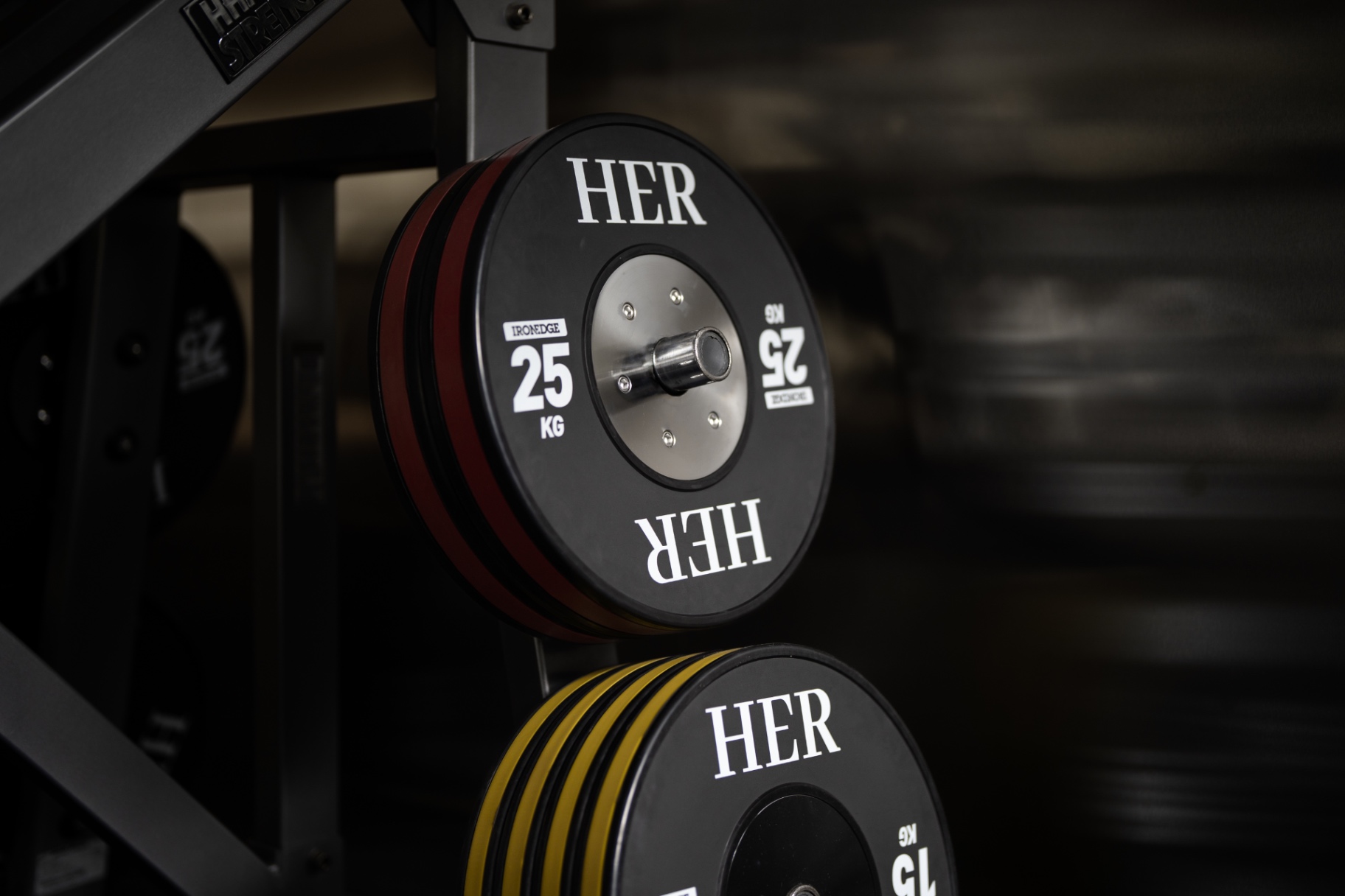 HER-branded weight plates on the strength rack